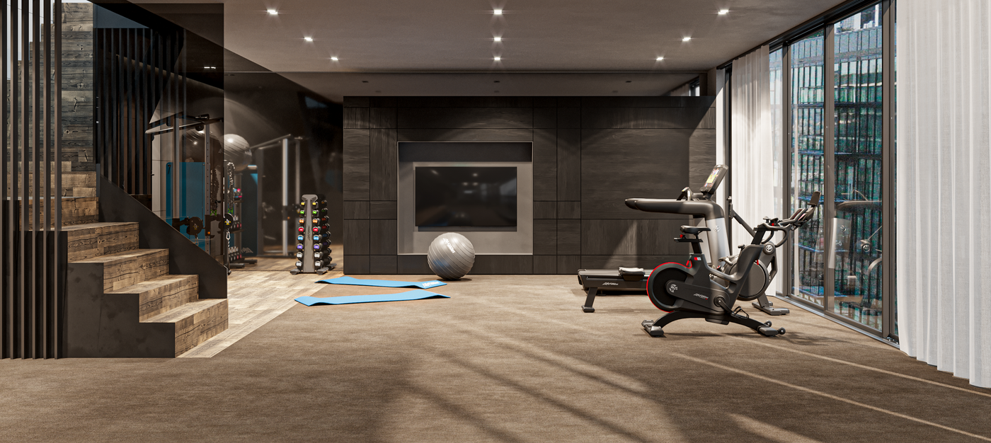 Modern gym interior with exercise equipment and large windows.